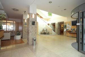 a lobby of a building with a large lobby at Hotel Lovec in Bled