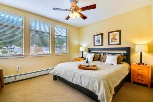 a bedroom with a bed with a ceiling fan and windows at Ski In Out Luxury Condo 4474 I Huge Hot Tub I Great Views I Best Price I FREE Adventures Daily in Winter Park +24 photos