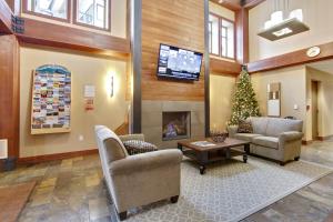 a lobby with a living room with a christmas tree at Ski In Out Luxury Condo 4474 I Huge Hot Tub I Great Views I Best Price I FREE Adventures Daily in Winter Park