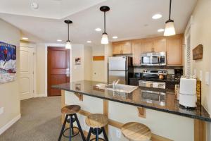 a kitchen with a counter and two stools at Ski In-Out Luxury Condo #4474 With Huge Hot Tub & Great Views - 500 Dollars Of FREE Activities & Equipment Rentals Daily in Winter Park