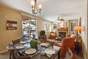 a dining room with a table and chairs and a living room at Ski In-Out Luxury Condo #4375 With Huge Hot Tub & Great Views - 500 Dollars Of FREE Activities & Equipment Rentals Daily in Winter Park