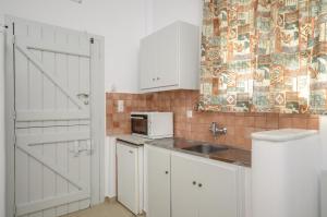 a kitchen with a sink and a microwave at Elma Studio in Mikri Vigla +22 photos