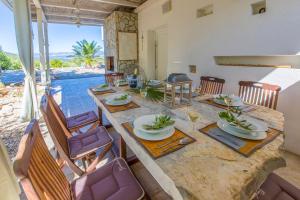 a dining room with a large table and chairs at Villa Vrbnik in Vrbnik