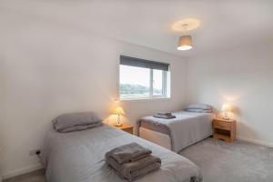 מיטה או מיטות בחדר ב-Grampian Serviced Apartments - Park View
