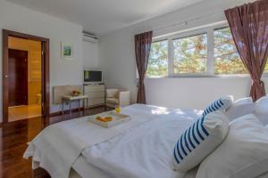 Postel nebo postele na pokoji v ubytování Villa Vrbnik