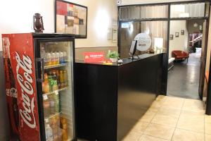 a coca cola refrigerator in a store at Casi Guemes Hotel in Córdoba