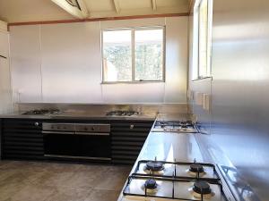 a kitchen with a stove and a counter top at Lake Ruataniwha Holiday Park in Twizel