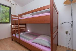 a couple of bunk beds in a room at Apartment Ametist in Milna