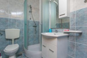 a bathroom with a toilet and a sink and a shower at Apartment Ametist in Milna +19 photos