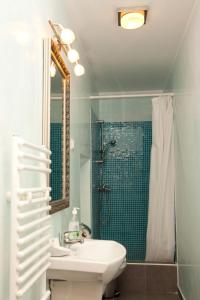 a bathroom with a sink and a shower at Pension Dinu Residence in Timişoara