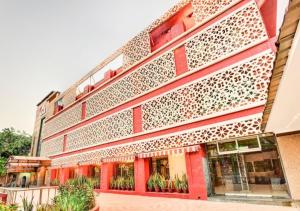 a facade of a building with red at Citi Club in Kānpur