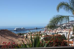 a view of a city with a ship in the water at ARTS IN Hotel Conde Carvalhal in Funchal