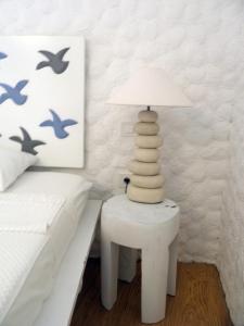 a white lamp sitting on a table next to a bed at Boutique Hotel Placa in Krk