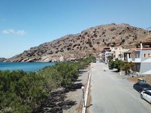 a street in a town next to the water at Apollon in Tsoutsouros