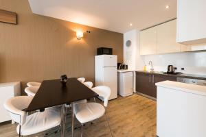 a kitchen and dining room with a table and chairs at Silver Mountain Apartment 26 in Poiana Brasov