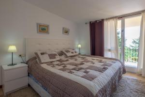 a bedroom with a large bed and a large window at Villa Montemar in Tossa de Mar +19 photos