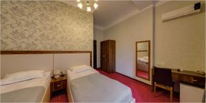 Postel nebo postele na pokoji v ubytování Hotel Avlabari