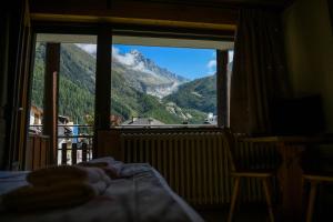 a bedroom with a view of a mountain through a window at Le Dahu in Chamonix