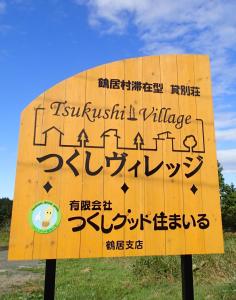 a sign in japanese language on the side of a road at Tsukushi Village in Tsurui