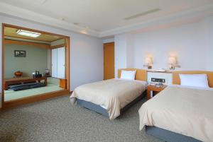 Un ou plusieurs lits dans un hébergement de l'établissement THE HOTEL YAKUSHIMA ocean & forest