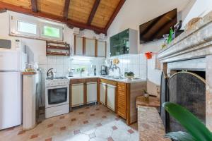a kitchen with a refrigerator and a stove top oven at Apartments Darija in Pučišća
