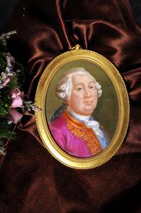 a painting of a woman in a gold frame next to flowers at Grand Hotel Entourage - Palazzo Strassoldo in Gorizia