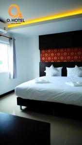 A bed or beds in a room at O2 Hotel สกลนคร (โรงแรม โอทู สกลนคร)