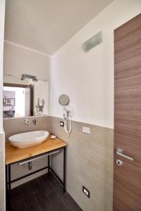 a bathroom with a sink and a mirror at La Terrazza sul Centro in Palermo