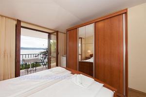 a bedroom with a bed and a view of the ocean at Apartment Danica in Brela