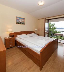 a bedroom with a large bed and a balcony at Apartment Danica in Brela