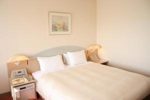 Postel nebo postele na pokoji v ubytování Kawagoe Prince Hotel