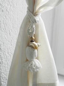 a curtain rod with a seashell on it at Boutique Hotel Placa in Krk