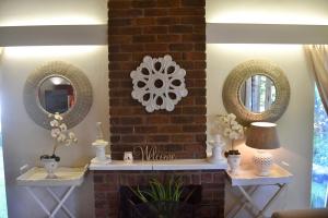 a living room with two mirrors and a fireplace at Retreat in Hillcrest +18 photos