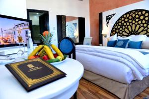 A bed or beds in a room at El Minzah Hotel