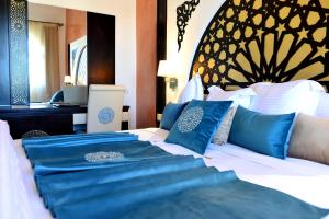 A bed or beds in a room at El Minzah Hotel