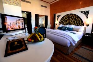 A bed or beds in a room at El Minzah Hotel