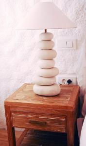 a white lamp sitting on top of a wooden table at Boutique Hotel Placa in Krk