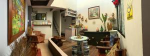 a living room with a table and chairs at Center Parkway Pension House in Kalibo
