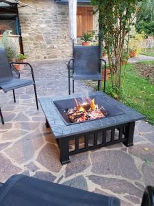 a fire pit on a patio with two chairs at La Casa nel Chianti in Greve in Chianti
