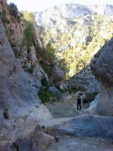 a person walking down a path in a rocky mountain at Casa Lamberdina in Parroquia de la Fuensanta