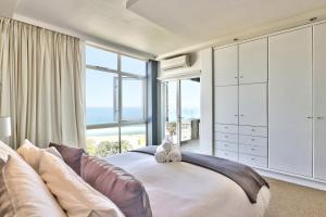 a bedroom with a large bed and a large window at Cloud Nine by Totalstay in Cape Town