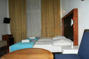 Postel nebo postele na pokoji v ubytování Hotel Garni Aaberna