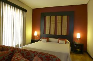 a bedroom with a large bed and a large window at Hotel Lisboa in Lisbon