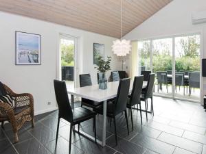 a dining room with a white table and chairs at 8 person holiday home in Tarm in Hemmet