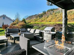 a patio with a grill and a table and chairs at 8 person holiday home in Valldal in Valldal