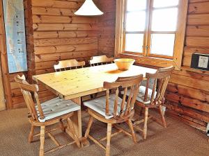 a wooden table and chairs in a room at 6 person holiday home in Ringk bing in Søndervig