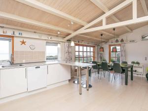 a kitchen and dining room with a table and chairs at Three-Bedroom Holiday home in Frørup 3 in Tårup