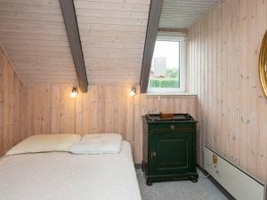 a small bedroom with a bed and a window at Two-Bedroom Holiday home in Hejls 10 in Hejls