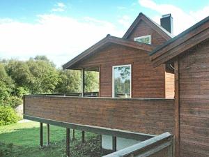 een huis met een groot terras aan de zijkant bij 5 person holiday home in VEVANG in Vevang