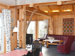 a living room with wood paneling and a fireplace at Three-Bedroom Holiday home in Blaksæter in Sølberg